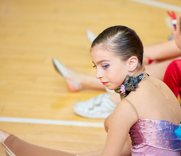 kid girl rhythmic gymnastics on wooden deck