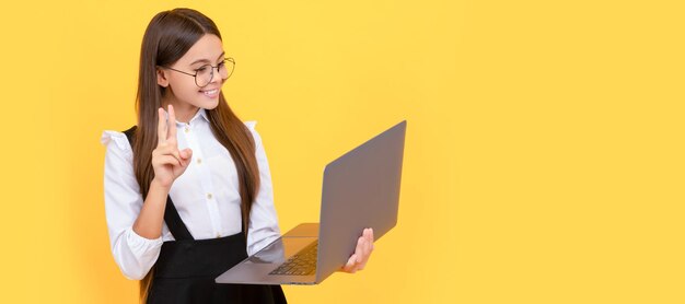 Kid in glasses teen girl use laptop for communication modern education School girl portrait with laptop horizontal poster Banner header with copy space