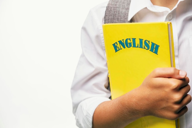 Kid holding english textbook closeup