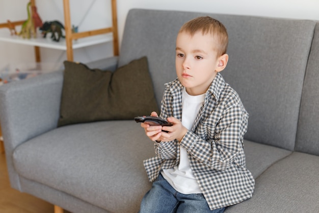 Kid holding TV remote controller