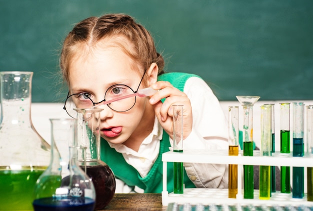 Photo kid learning chemistry at school