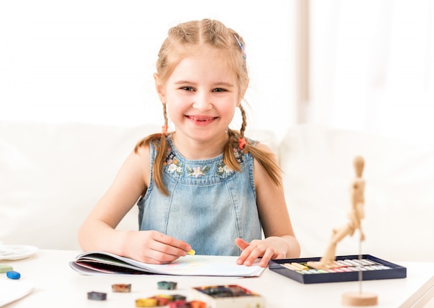 Kid learning to draw with dry pastel