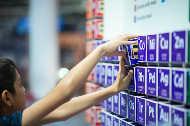 Kid learning periodic table in the classroom at school