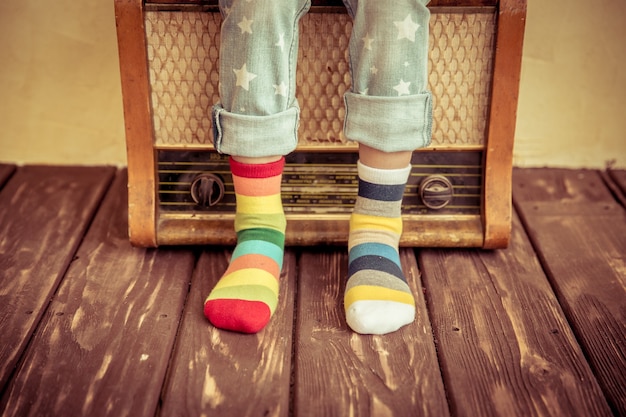 Kid listen music at home. Hipster child with retro vintage radio