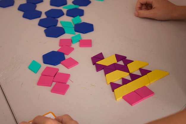 Kid making colorful plastic toy close up