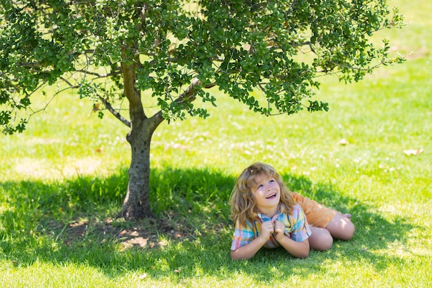 Kid on nature kids playing outdoors in spring park freedom and carefree happy childhood relaxing kid