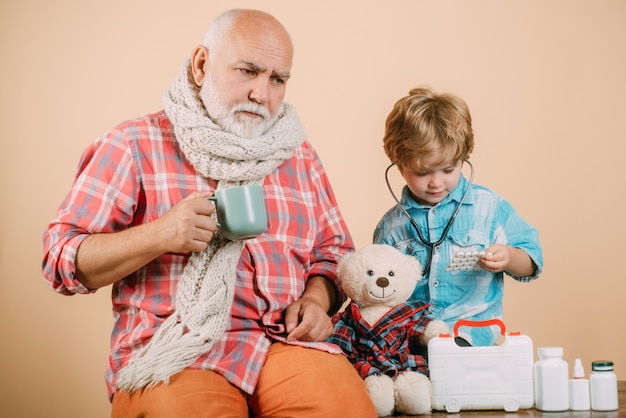 Kid play doctor with dad on color background boy doctor playing with dad smiling kid doctor and old ...