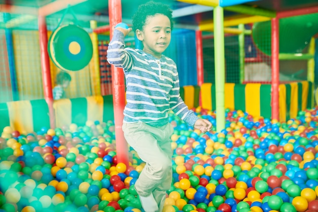 Kid Playing in Ball Pit