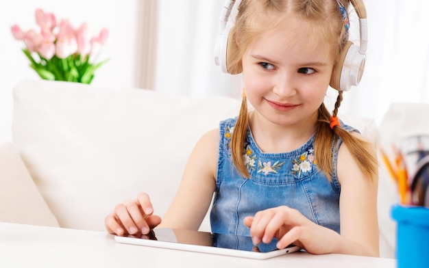 Kid playing games at tablet at home