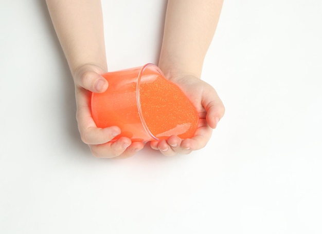 Kid playing hand made toy called slime Kids hands playing slime toy Making slime Top view Flatlay Selective focus