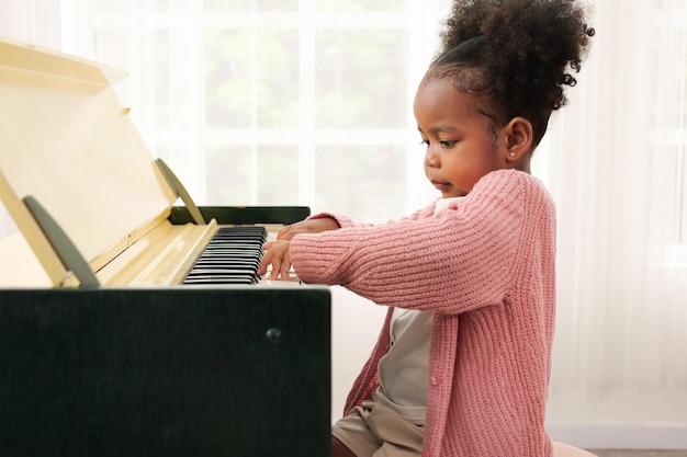 Kid playing piano daughter in piano class happy kid playing piano