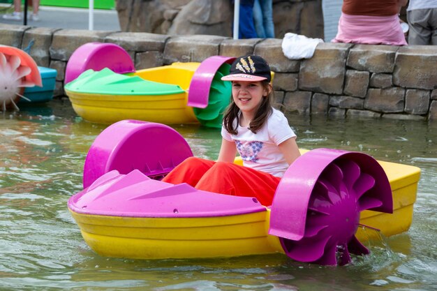 Kid playing rowing water paddle boat soft focus  high quality photo