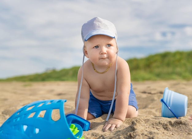 Kid playing in the sand by the sea