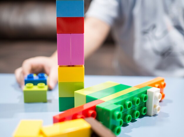 Kid playing with color toy blocks