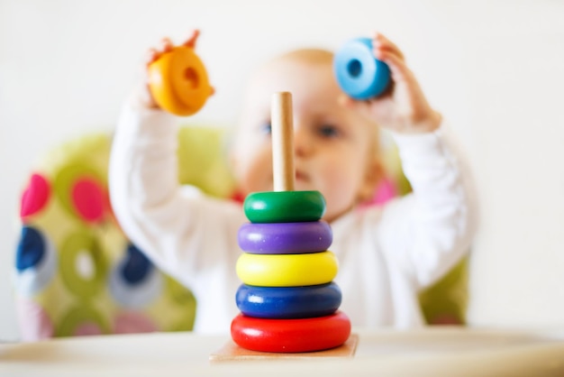 The kid plays the pyramid child playing with wooden toys