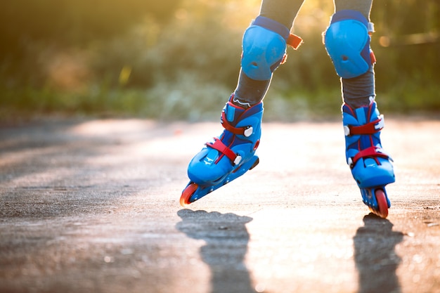 Kid riding on roller skates in the park 