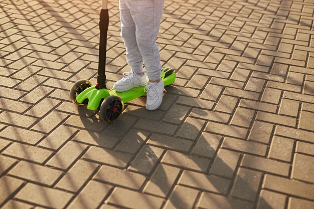 Kid riding scooter on street