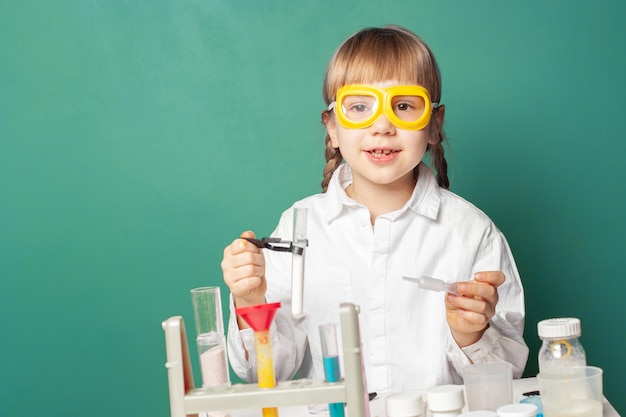 Kid scientist making experiments in home or school laboratory Child and science education concept