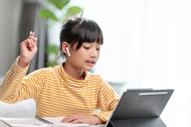 Kid self isolation using tablet for his homeworkchild doing\
using digital tablet searching information on internet during covid\
19 lock downhome schoolingsocial distanceelearning online\
education