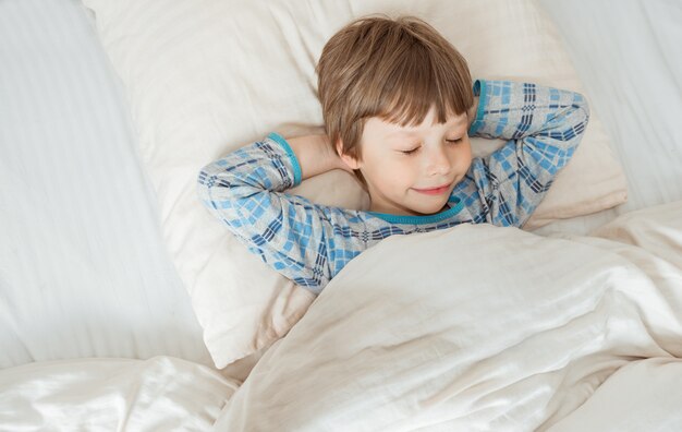 Kid sleeping on bed