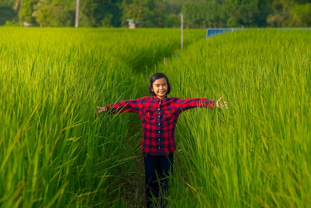 Kid smile and standing in organic rice field