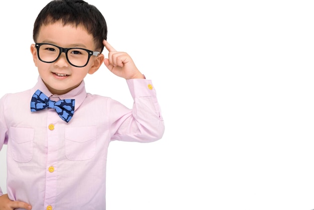 Kid standing over white background smiling and pointing to head with one finger