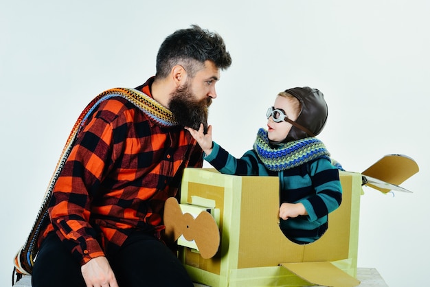 Photo kid travel on toy airplane. traveling to the wonderland. child sitting in airplane. kid playing pilot