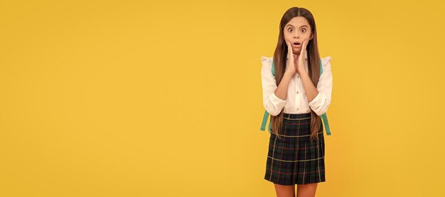 Kid in uniform on yellow background september 1 childhood Horizontal isolated poster of school girl student Banner header portrait of schoolgirl copy space