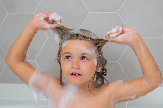 Kid washing hair soap on child head child face in foam kid bathing in a bath with foam funny kid fac