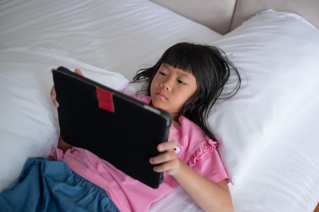 Kid watching tablet child addicted cartoonxA