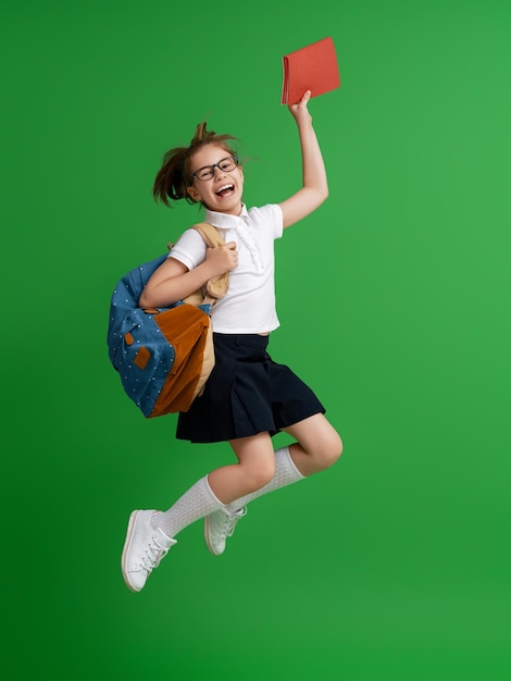Kid with backpack on color background