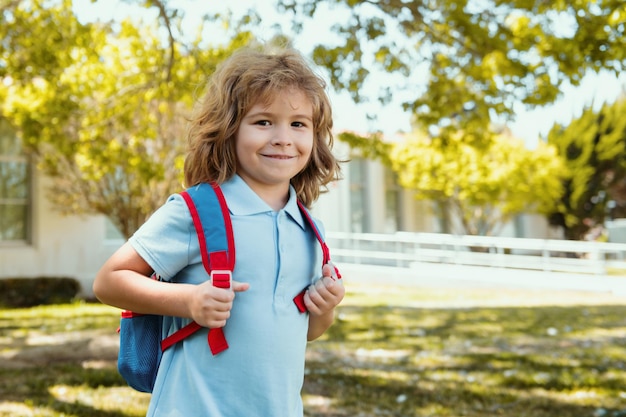 kid with backpack going to school kids education concept child with rucksacks standing in the park n