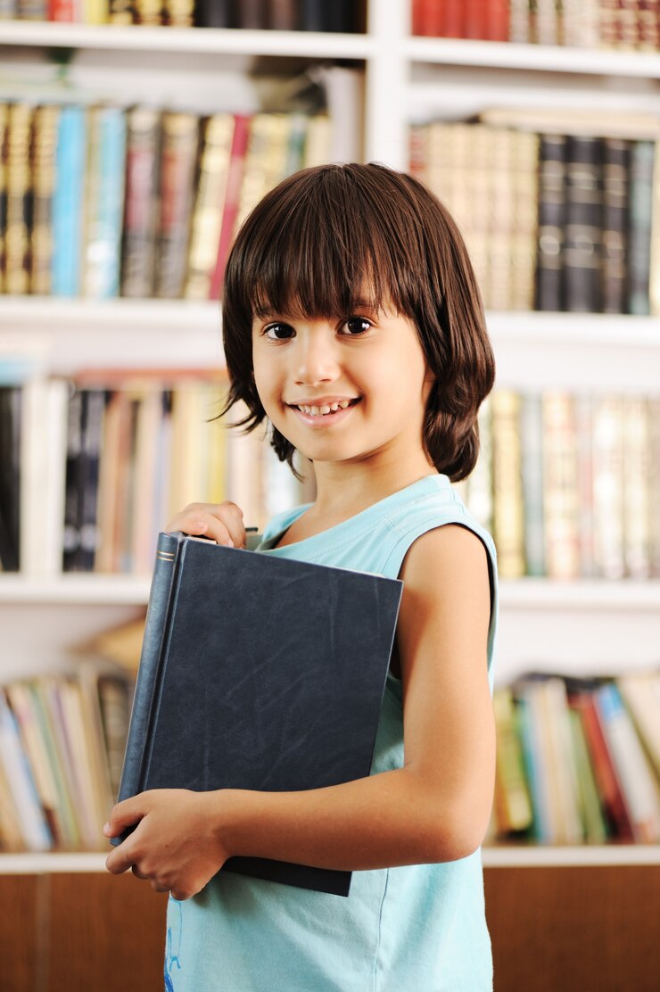 Kid with book in library