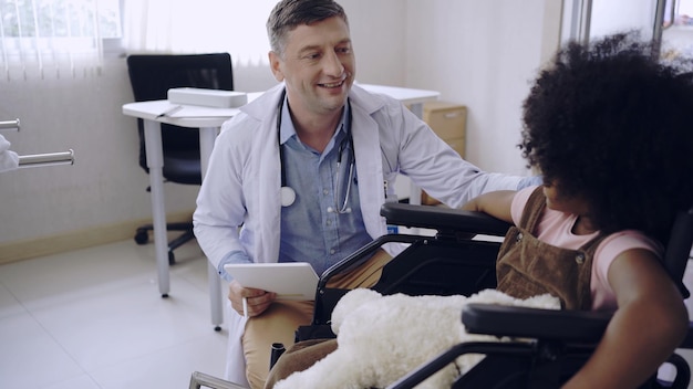 Kid with doctor at hospital. Children health and wellness.