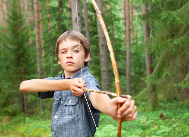 Kid with homemade bow and arrow