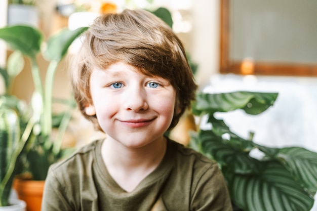 Kid with a lot of plant indoors