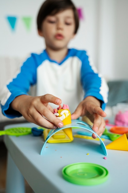 Kid with playdough front view