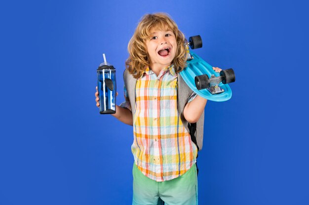 Kid with skateboard Child hold skate board and water bottle Healthy sport and activity for school 