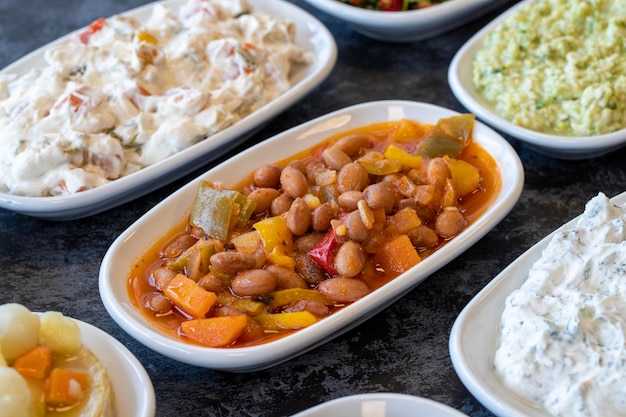 Kidney bean appetizer traditional turkish and arabic cuisine\
meze snack meal served alongside the main coursebulk appetizer\
plates natural vegetarian food barbunya plaki chili beans