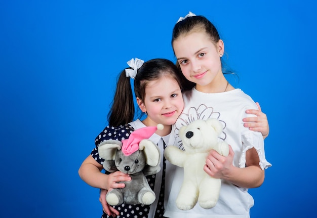 Kids adorable cute girls play with soft toys Happy childhood Child care Sisters or best friends play Sweet childhood Childhood concept Preparing for life Toys store Love and friendship