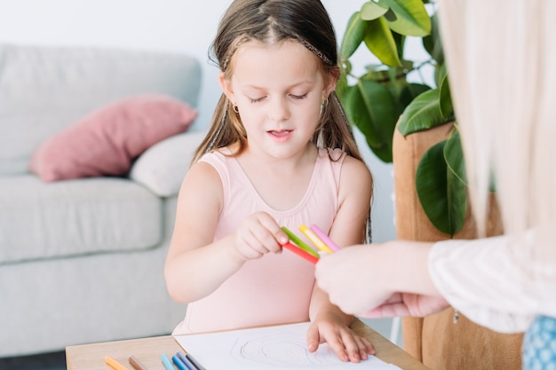 Kids artistic leisure. painting art hobby. little girl and her mom drawing pictures with pencils.