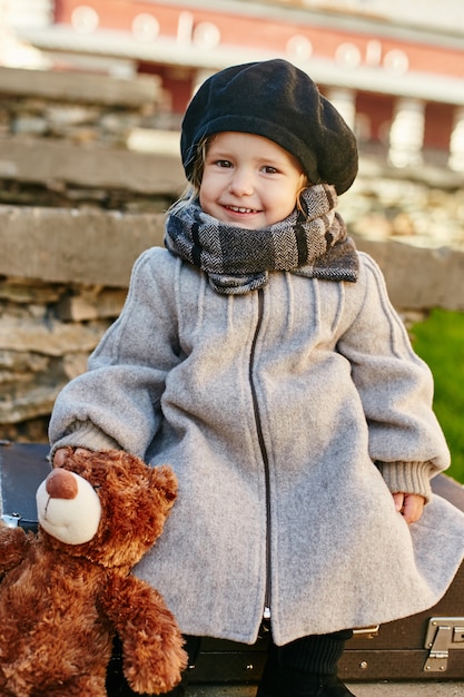 Kids baby in retro autumn spring clothes. Small child sitting smiling in nature