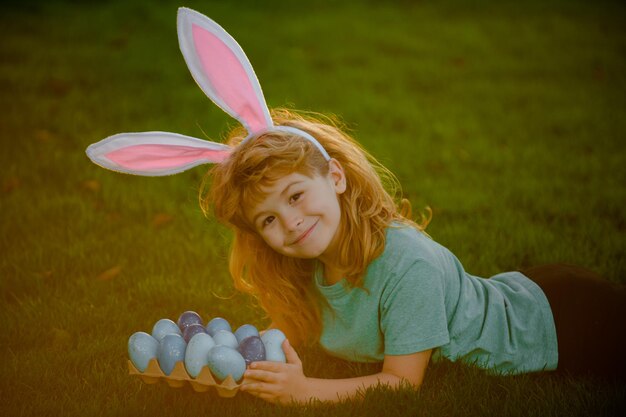 kids boy in rabbit costume with bunny ears hunting easter eggs easter bunny children