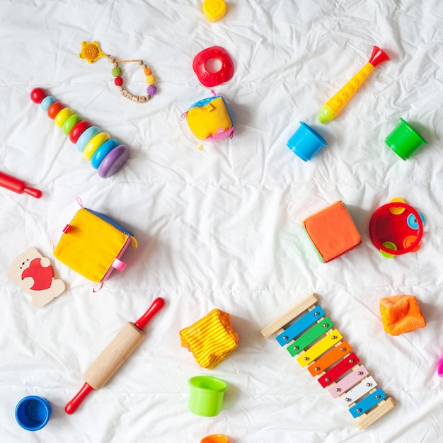 Kids bright colorful toys frame on white background. Top view. Flat lay. Copy space for te