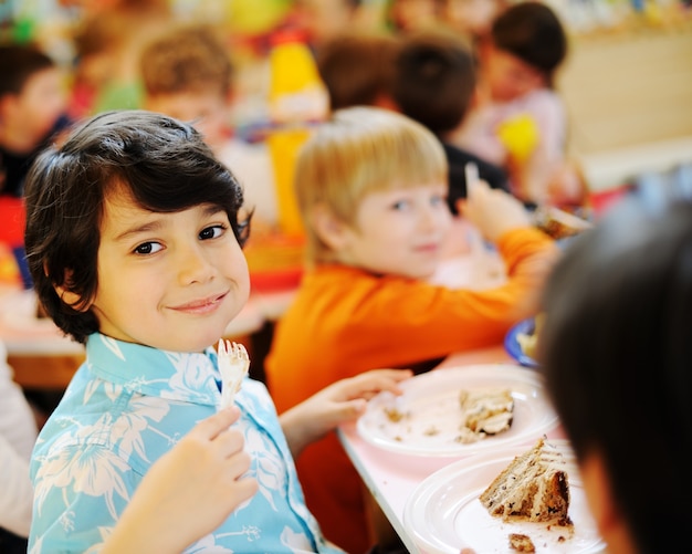 Kids celebrating birthday party in kindergarden playground