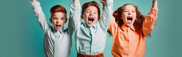 Kids cheering and celebrating on blue background studio