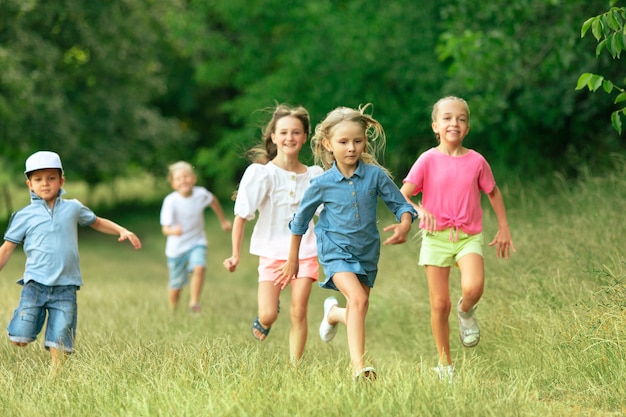 Kids children running on meadow