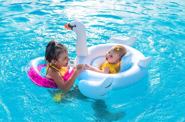 Kids in a circle floats in the sea. 