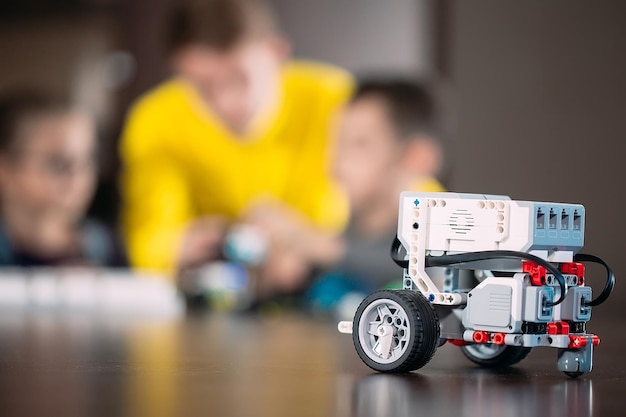 Kids creating robots with teacher. Early development, diy, innovation, modern technology concept.