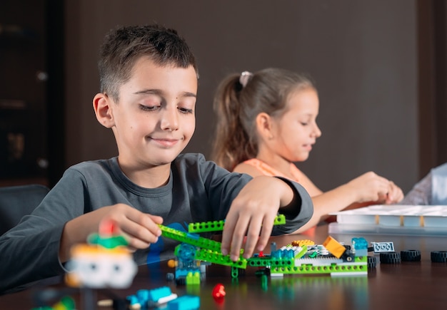 Kids creating robots with teacher.